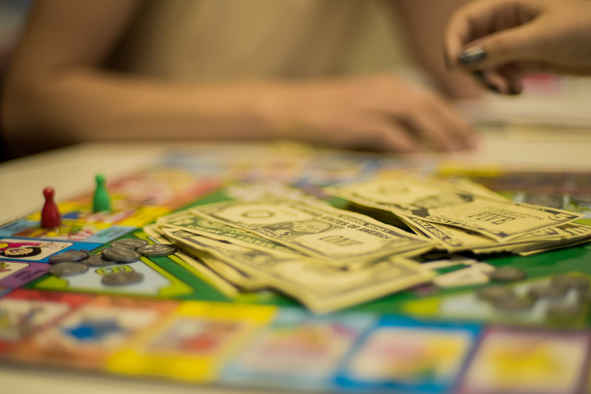 Children practicing money and math skills while playing a colorful board game